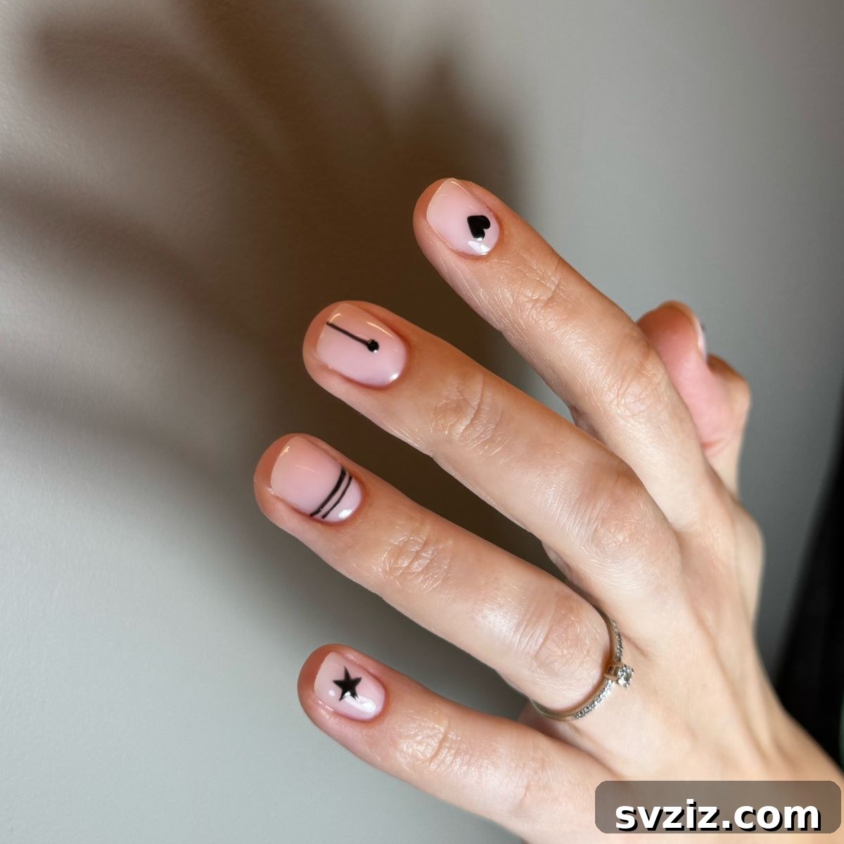 41 Effortless Nude Nail Ideas for Everyone 33 Minimalist yet eye-catching nail art on nude nails, highlighting sophisticated designs.