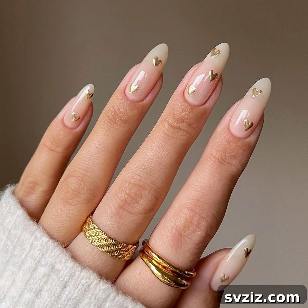 41 Effortless Nude Nail Ideas for Everyone 35 Long and elegant nude nails adorned with delicate gold hearts, perfect for bridal showers or Valentine's Day.