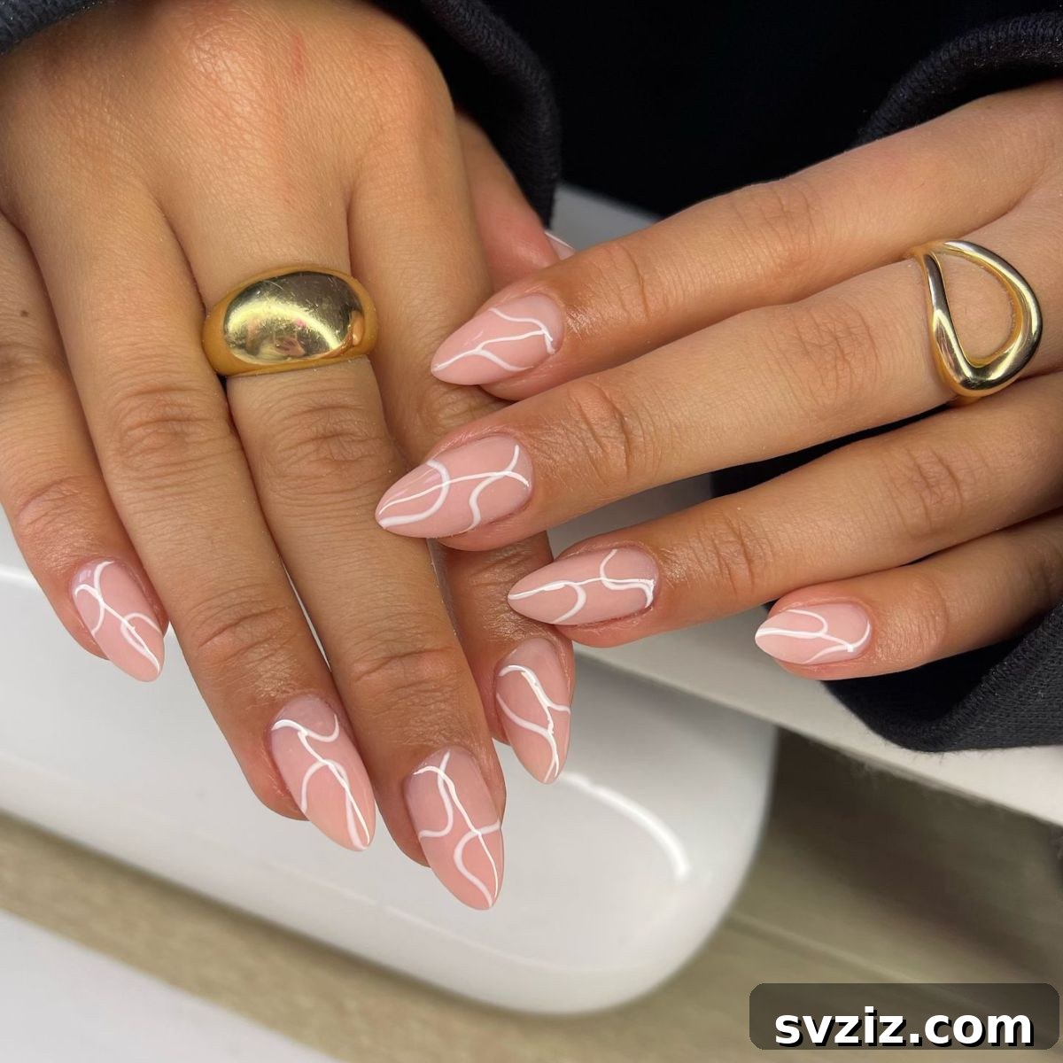 41 Effortless Nude Nail Ideas for Everyone 42 Elegant minimalist artsy nude nails with soft white designs, offering a sophisticated and eye-catching look year-round.