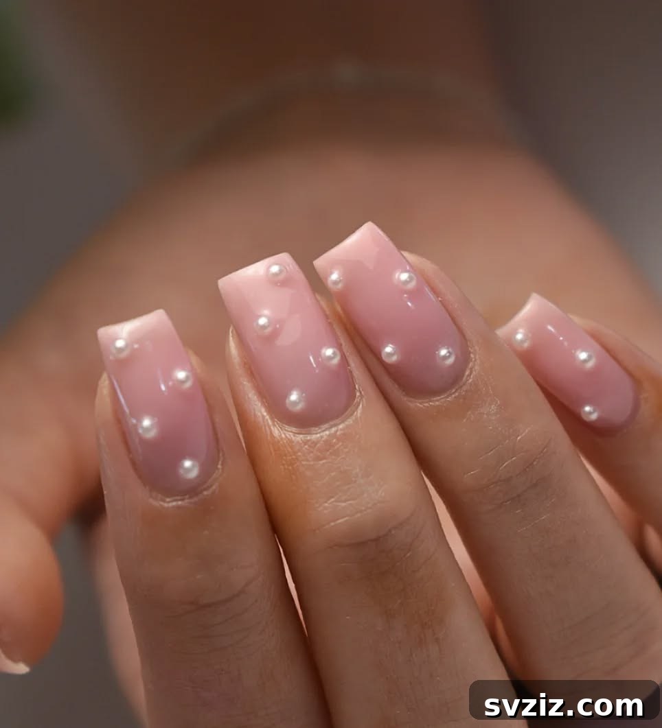41 Effortless Nude Nail Ideas for Everyone 43 Romantic pink nude nails adorned with delicate pearls, perfect for weddings, bridal showers, or elegant occasions.