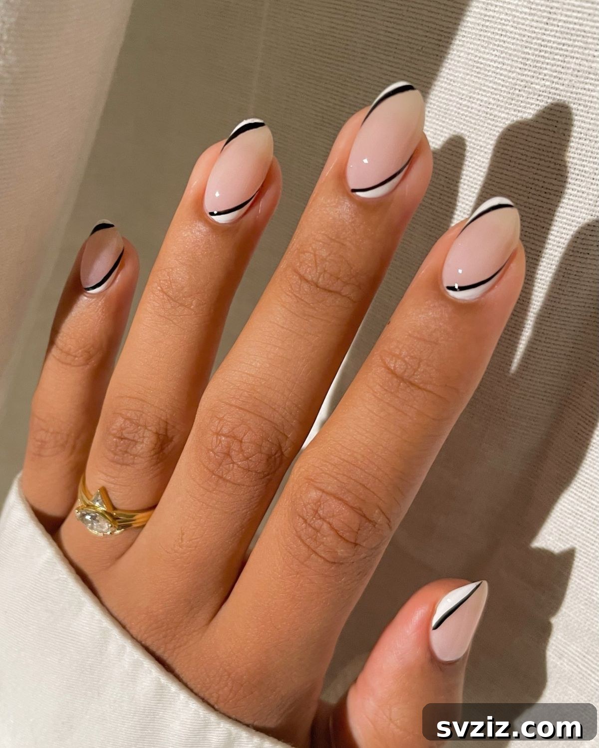41 Effortless Nude Nail Ideas for Everyone 9 Striking black, white, and nude nail art, creating a modern and sophisticated contrast.