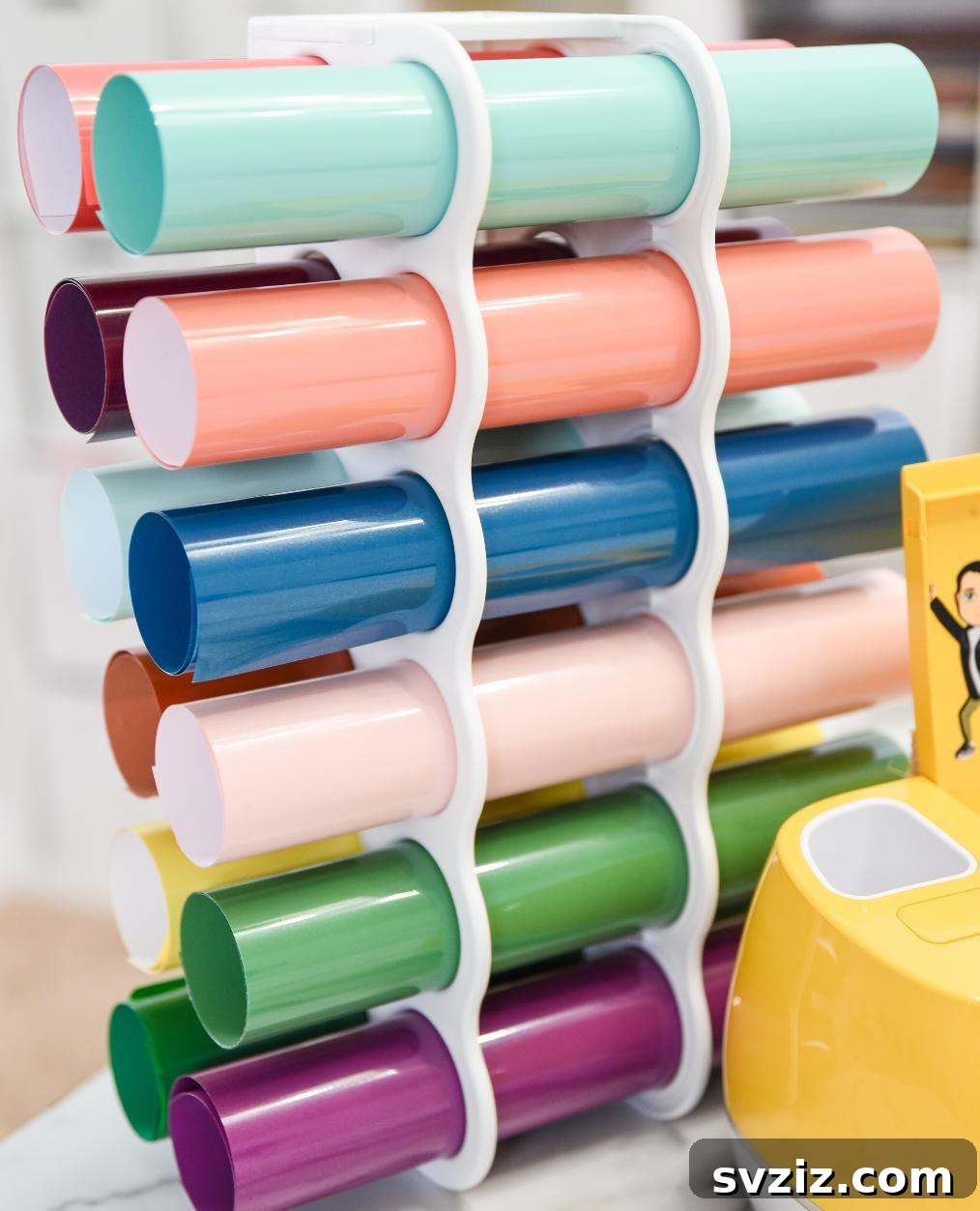 Vinyl roll storage rack displaying rolls of crafting vinyl in various colors, neatly organized.