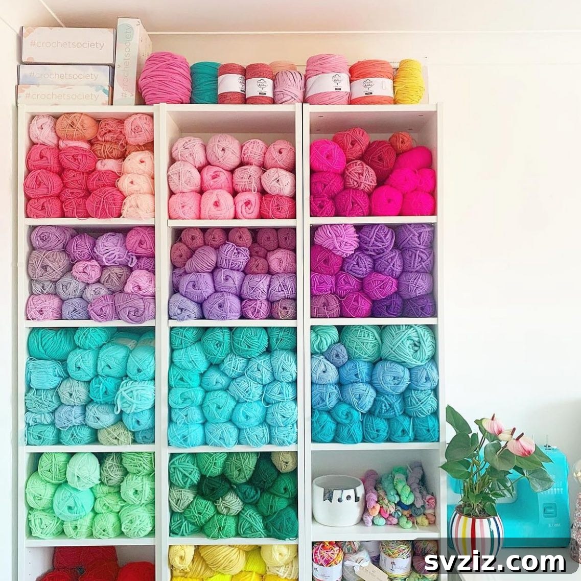 Yarn cubbies organizing colorful skeins of yarn, neatly arranged by color in a craft room.