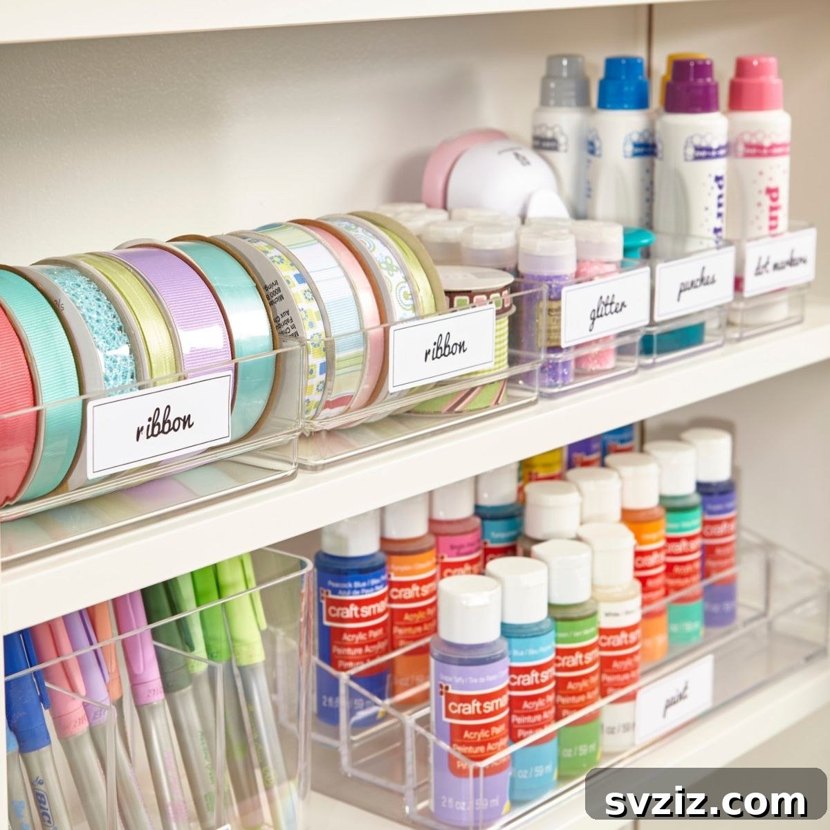 Labeled drawer organizers in a craft room, neatly separating various small supplies like beads and pens.