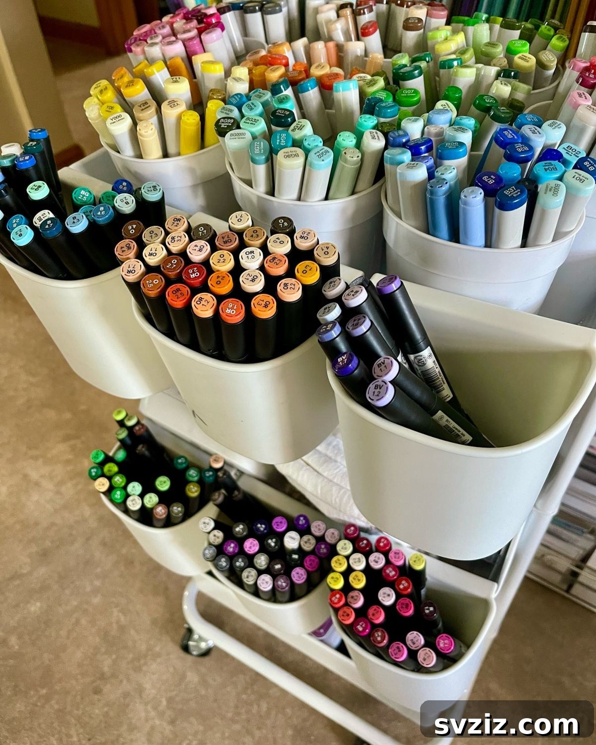 Mobile color cart with cups for organizing pens, markers, and other art supplies by color.