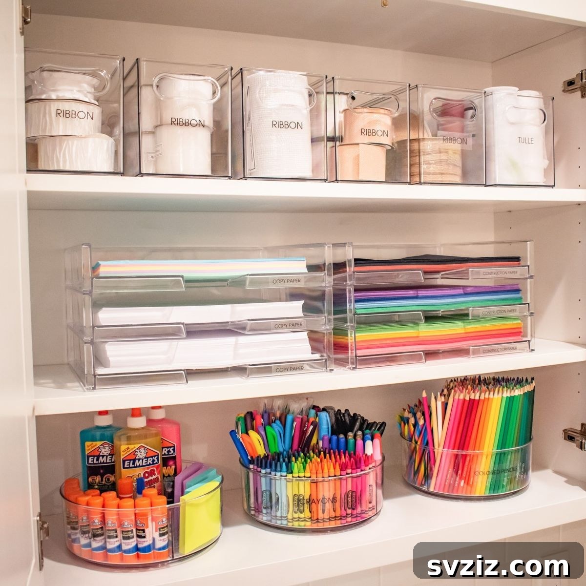 Clear acrylic organizers for craft supplies, showcasing neat storage of various items.