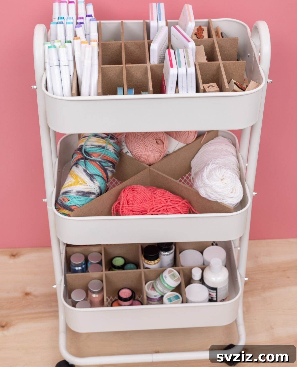 Mobile craft cart with cubbies, organizing various craft supplies and tools.