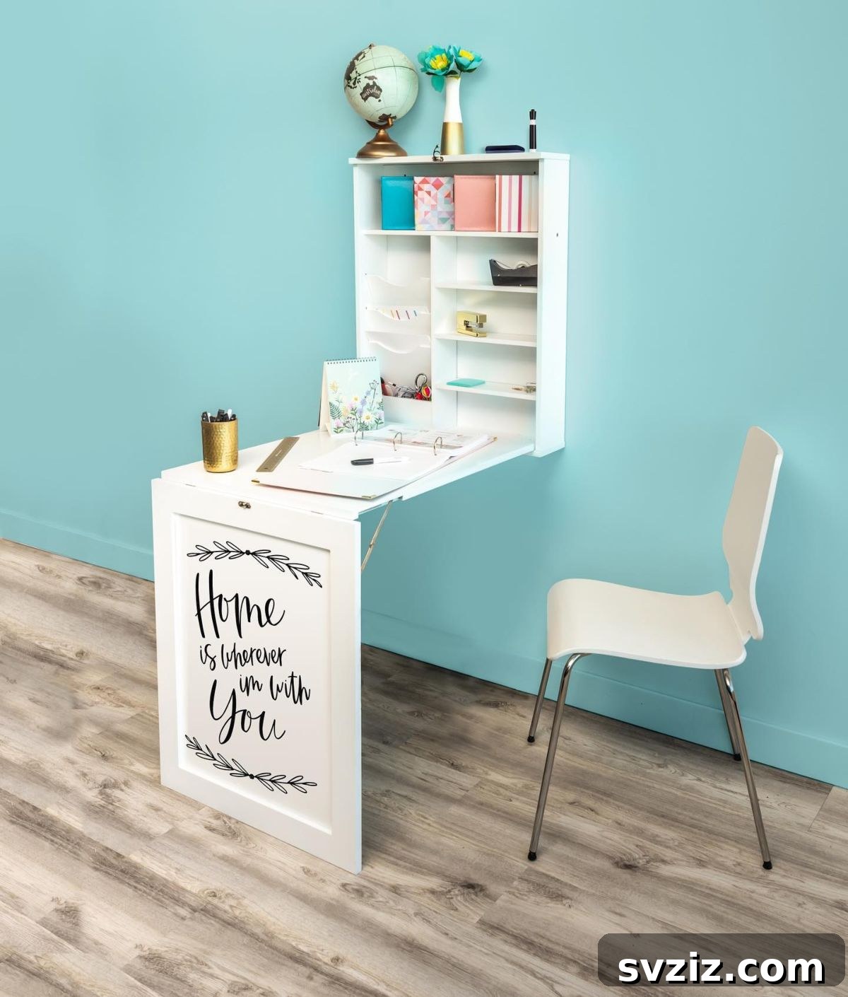Space-saving fold-down desk in a small craft room, providing a temporary workspace.