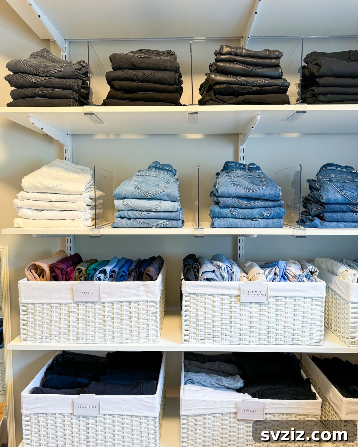 Neatly folded jeans organized by color on closet shelves