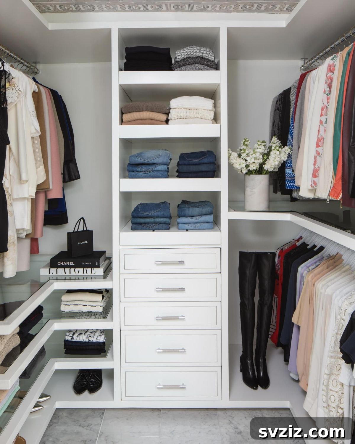 Luxurious custom-built closet with glass shelving and pull-outs