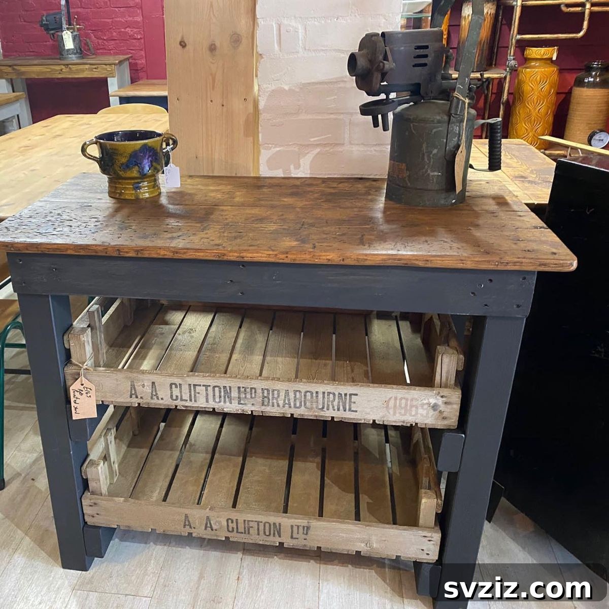 Kitchen island made from reclaimed wood, featuring a jeweler's workbench top and vintage crate shelves