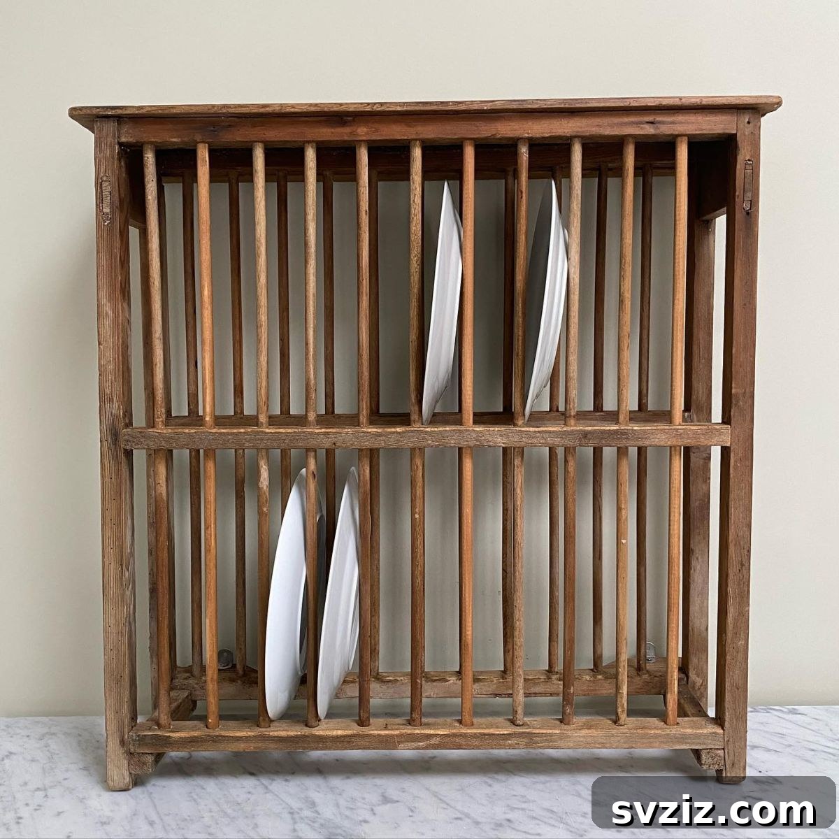Smart Plate Organization Ideas for a Perfectly Tidy Kitchen 12 Charming two-tier plate rack on a kitchen countertop, holding plates and bowls for display and easy access.