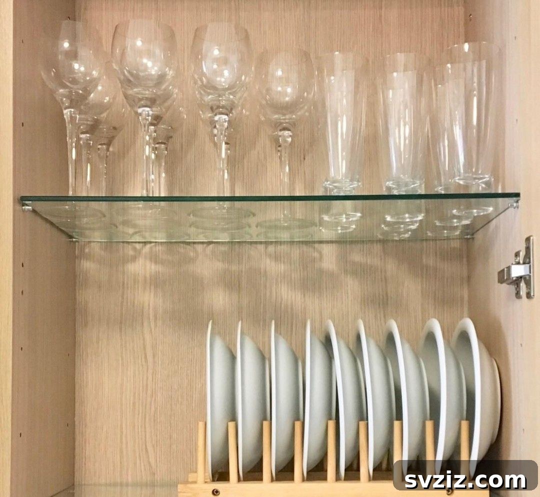 Smart Plate Organization Ideas for a Perfectly Tidy Kitchen 19 Minimalist wooden plate holder inside a kitchen cabinet, organizing plates and bowls vertically.