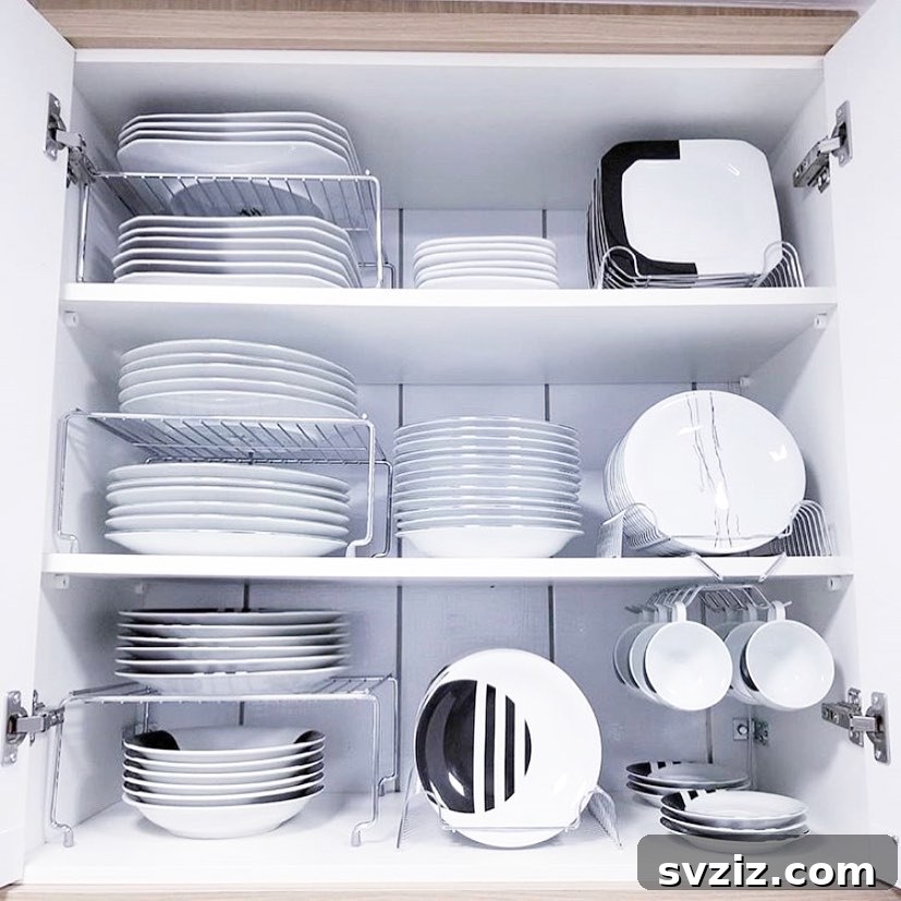 Smart Plate Organization Ideas for a Perfectly Tidy Kitchen 7 Kitchen cabinet with chrome plate shelves separating stacks of plates, bowls, and serving dishes.