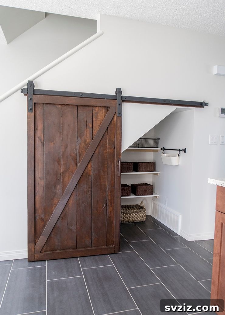 Reimagine Your Stairs: 23 Smart Storage Ideas for Hidden Spaces 22 Under Stairs Pantry with Barn Door