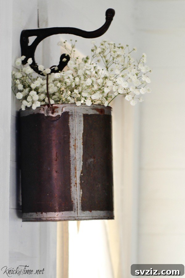 Smart Hacks for Repurposing Paint Cans 15 15. Hanging Flower Holder
