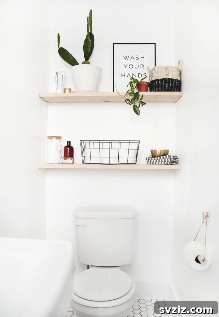 21 Smart Ways to Utilize the Space Above Your Toilet 17 Minimalist wooden shelves above a toilet with simple decor.
