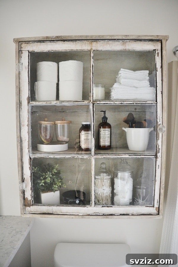 21 Smart Ways to Utilize the Space Above Your Toilet 18 Charming DIY antique window bathroom cabinet over a toilet.