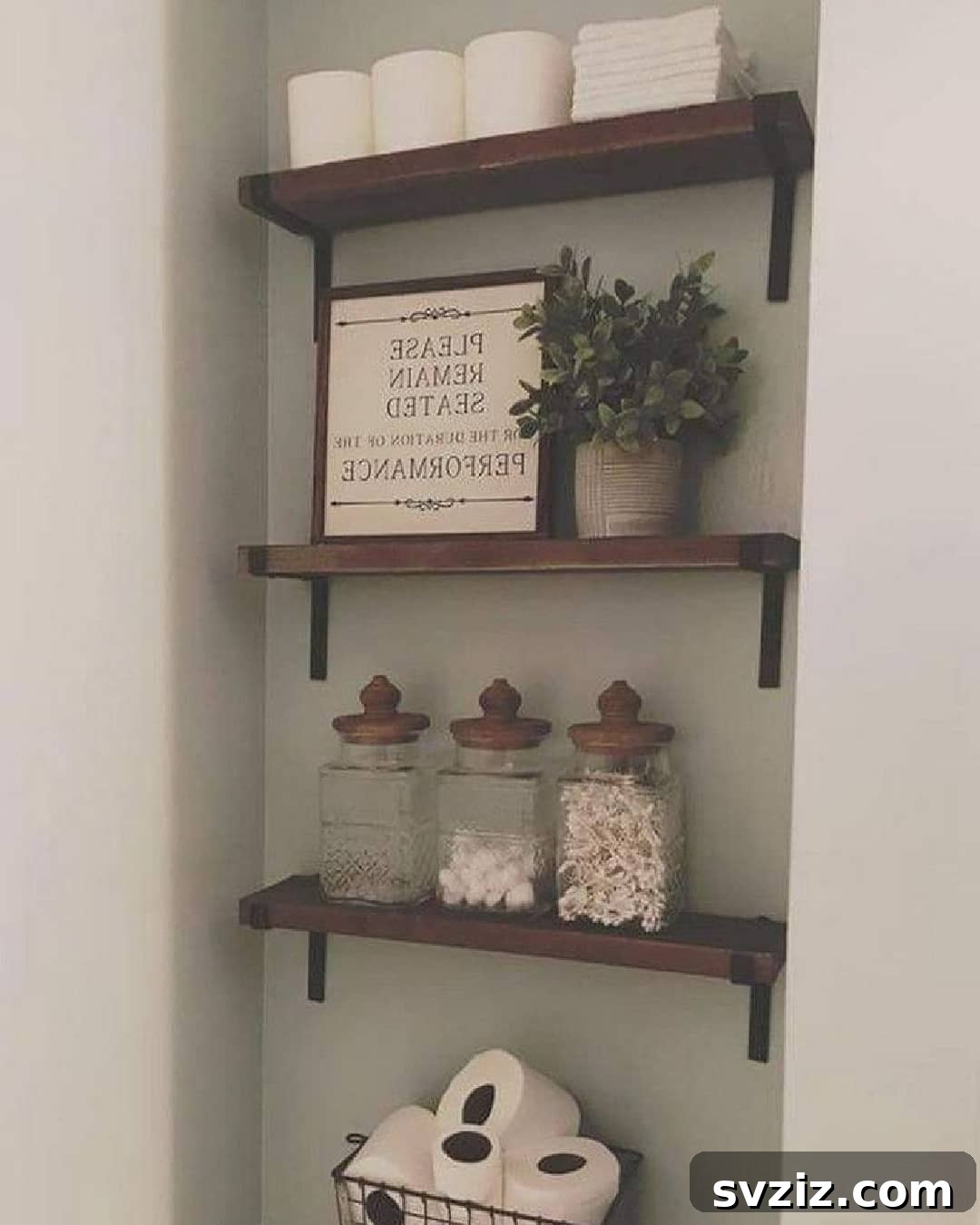 21 Smart Ways to Utilize the Space Above Your Toilet 22 Elegant glass jars used for organizing bathroom essentials on a shelf.
