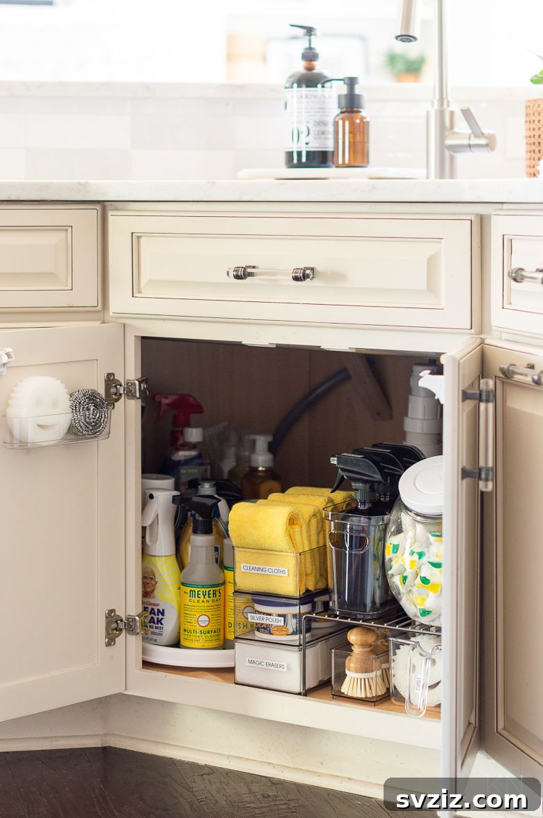 13 Genius Ways to Organize Your Sink Area 13 Shelf risers creating multiple levels for organizing cleaning supplies under a kitchen sink, maximizing vertical space.