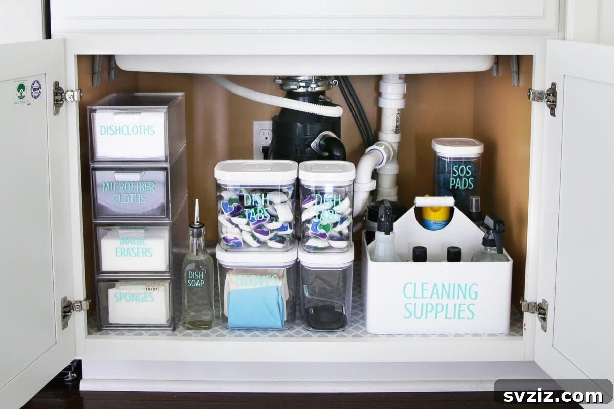 13 Genius Ways to Organize Your Sink Area 14 Stackable clear containers organizing various items under a kitchen sink, offering flexible and efficient storage solutions.