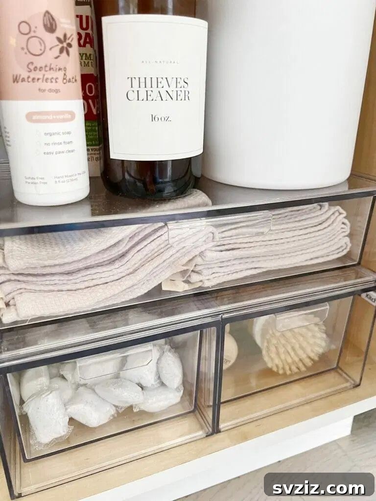 13 Genius Ways to Organize Your Sink Area 15 Clear acrylic storage drawers neatly organized under a kitchen sink, providing accessible and visible storage for small items.