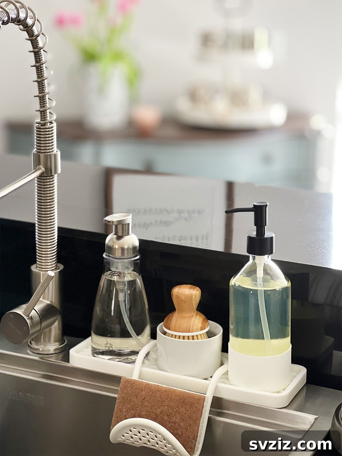 13 Genius Ways to Organize Your Sink Area 5 Elegant small vanity tray organizing soap, lotion, and a sponge next to a kitchen sink, enhancing countertop aesthetics.