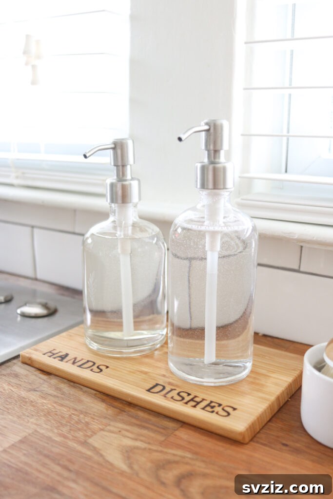 13 Genius Ways to Organize Your Sink Area 8 DIY wood-burned soap dispenser tray with soap and sponge, preventing drips and enhancing kitchen sink organization.
