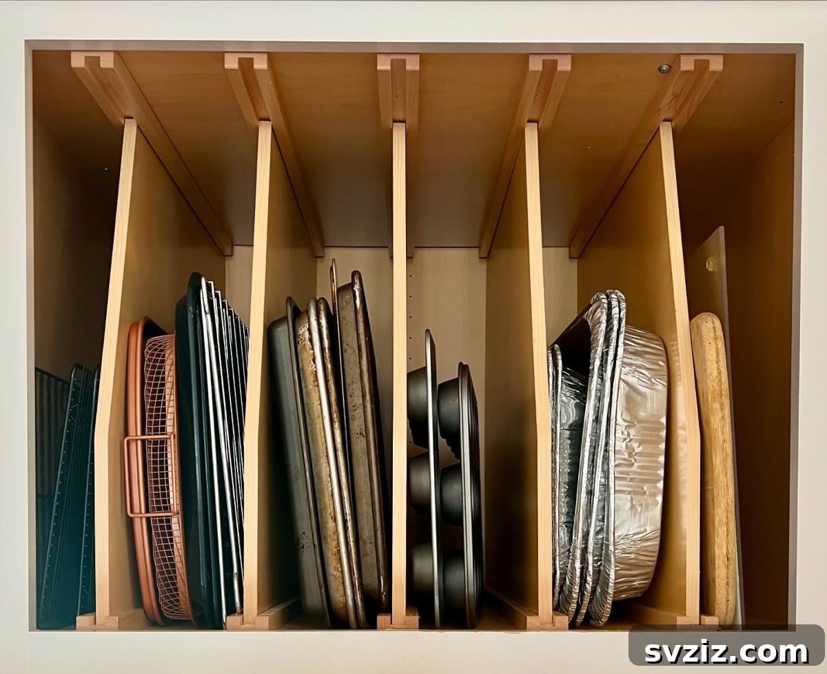 Baking trays and pans stored vertically in a cabinet organizer