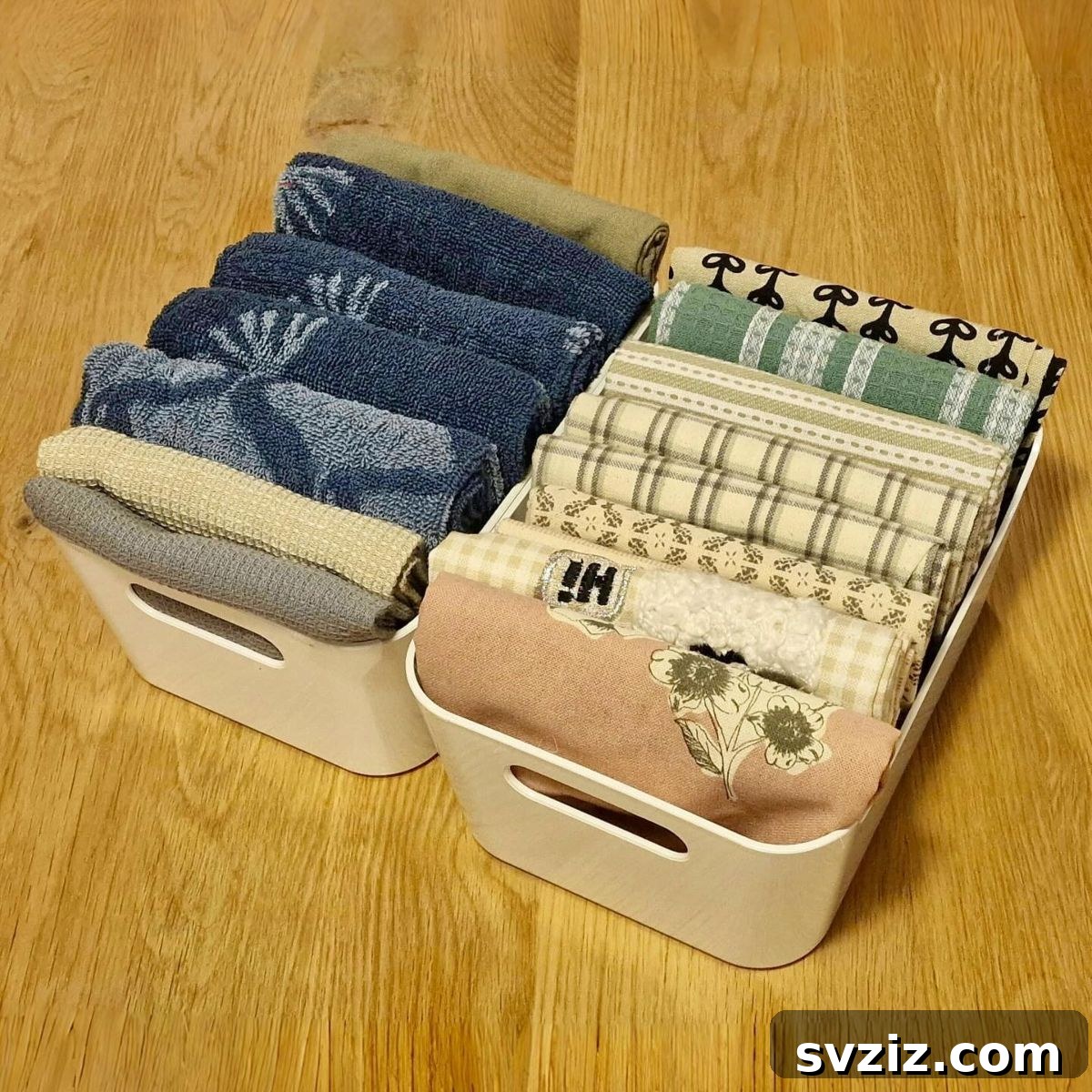 Neatly folded tea towels stored in decorative boxes