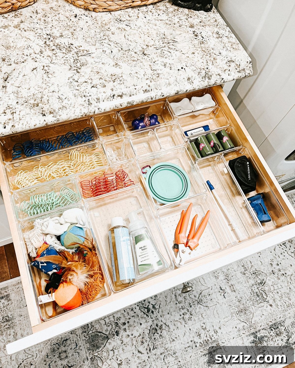 Neatly organized pet supplies in a drawer using dividers