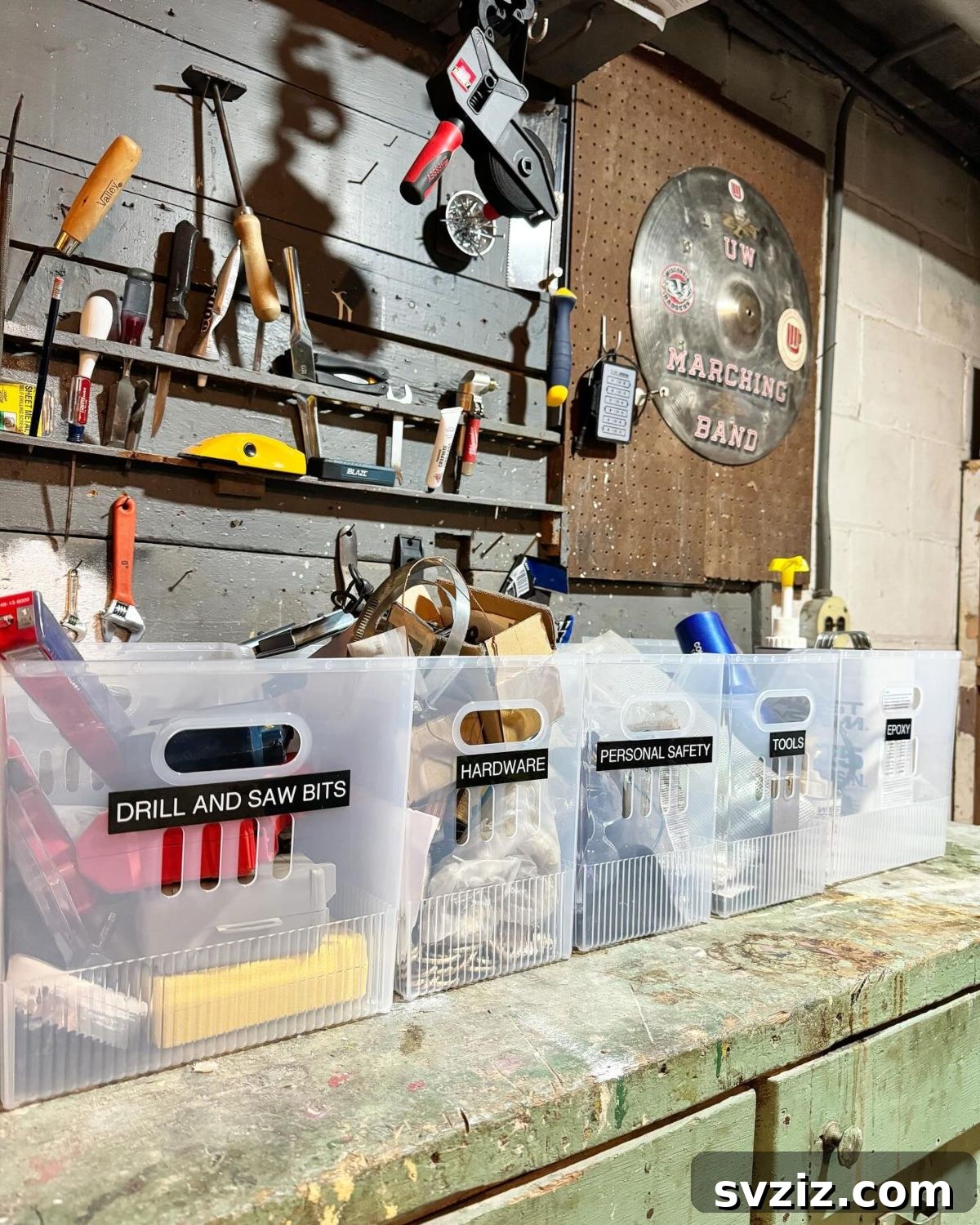 Labeled storage bins organizing tools on a workbench