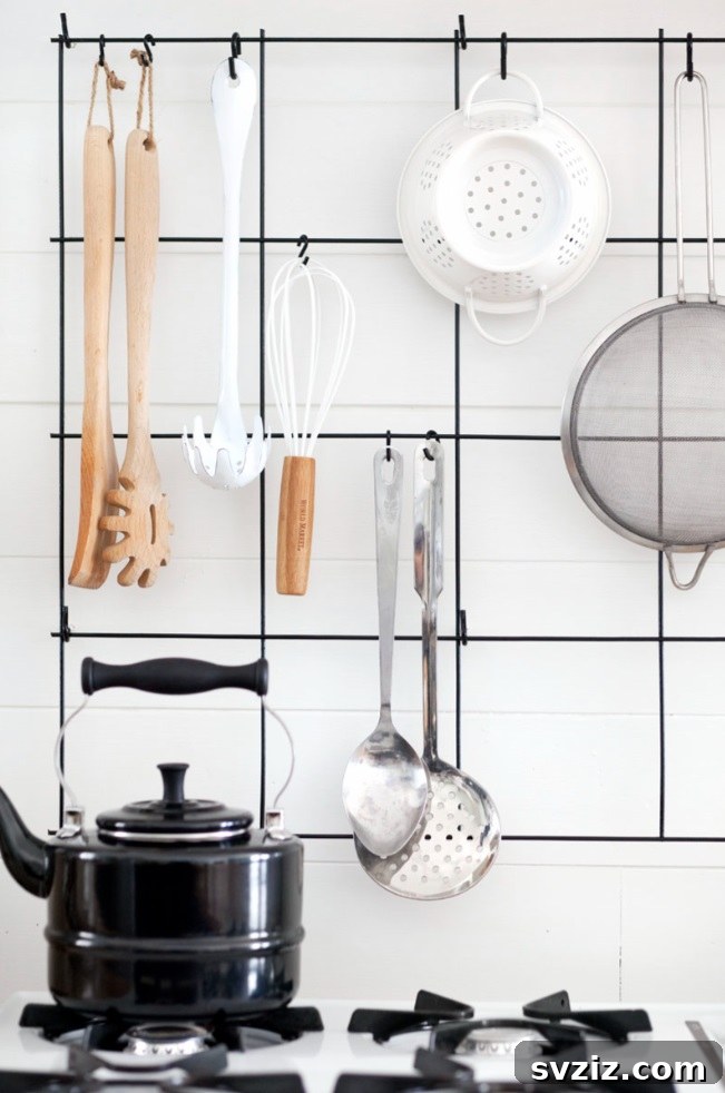 17 Smart Utensil Organizing Hacks 12 Elegant DIY wire utensil rack holding various kitchen tools, showcasing a clean and organized aesthetic