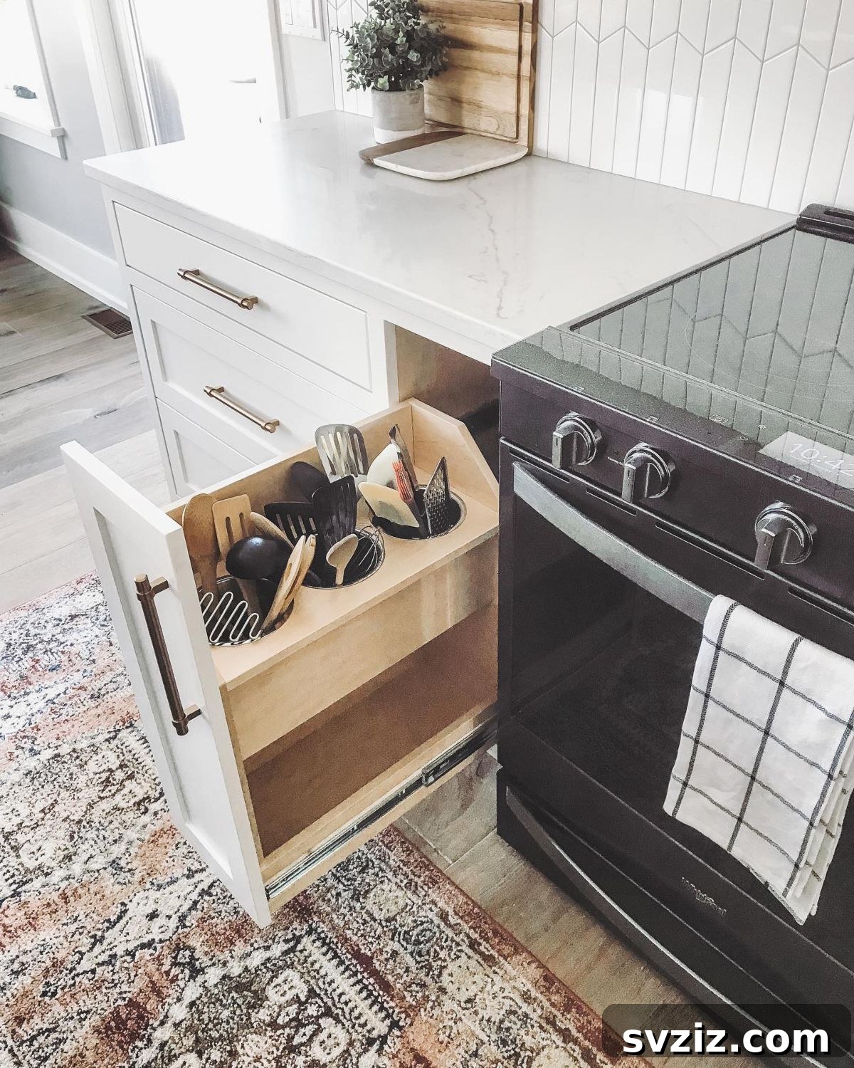 17 Smart Utensil Organizing Hacks 15 Modern kitchen featuring a pull-out utensil storage cabinet, showcasing organized cooking tools