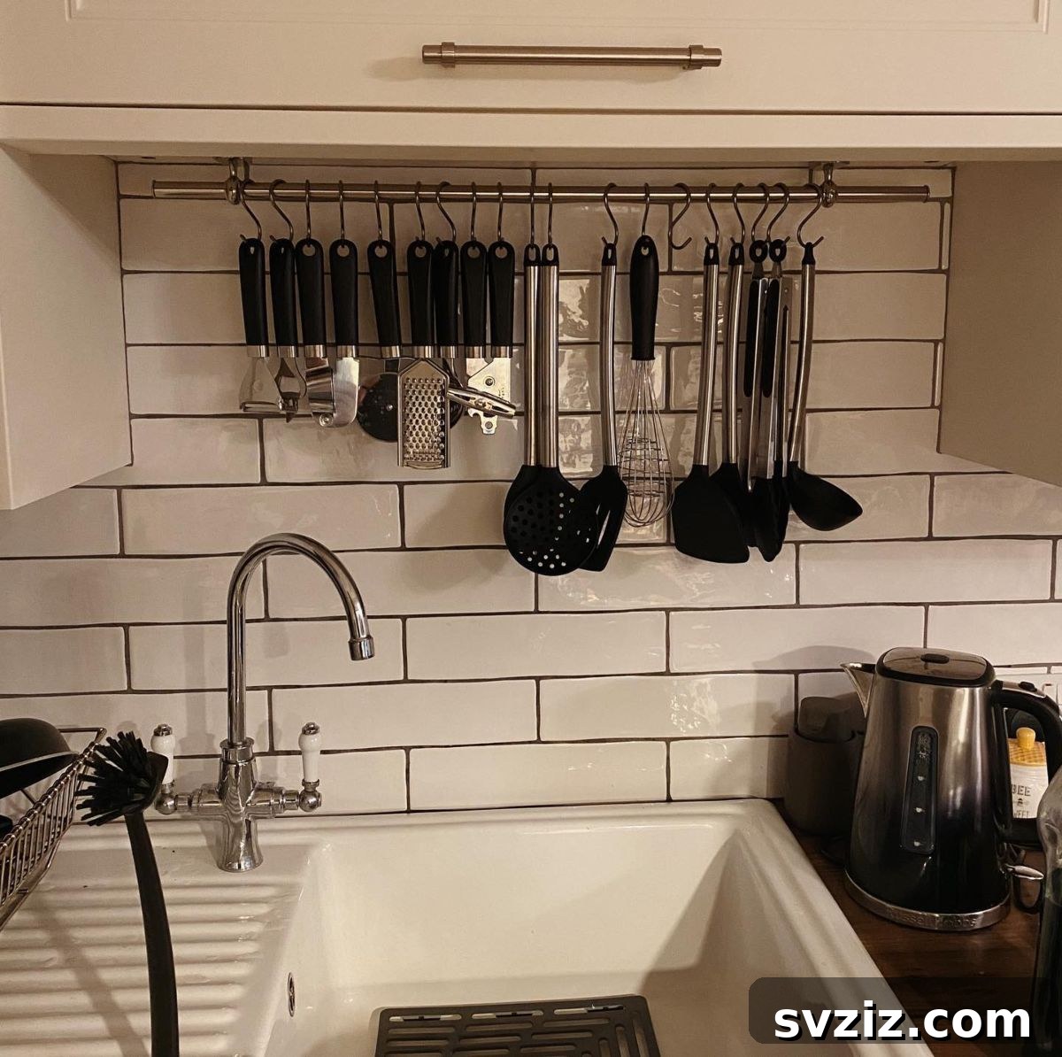 17 Smart Utensil Organizing Hacks 19 Kitchen utensils neatly hung on a rod using S-hooks, demonstrating an efficient vertical storage solution