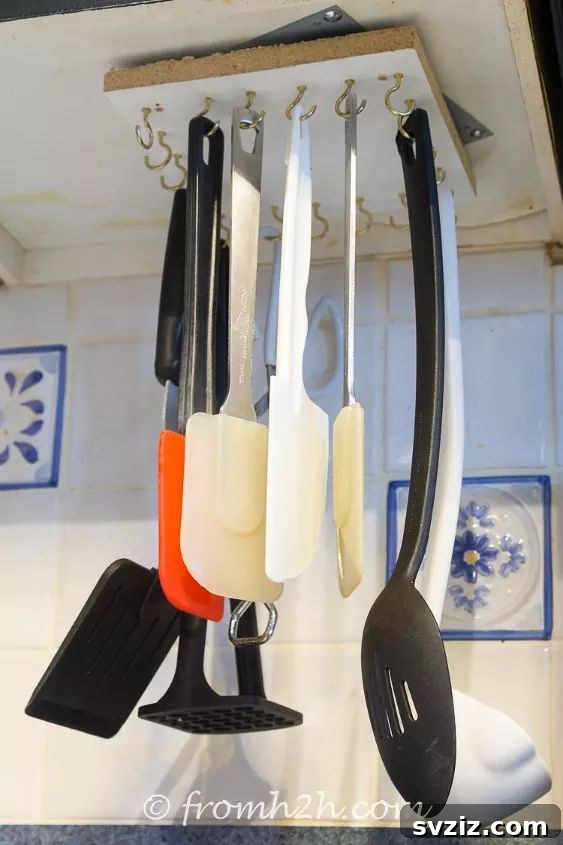 17 Smart Utensil Organizing Hacks 4 DIY rotating cooking utensil storage rack made with Lazy Susan hardware, holding various spatulas and spoons