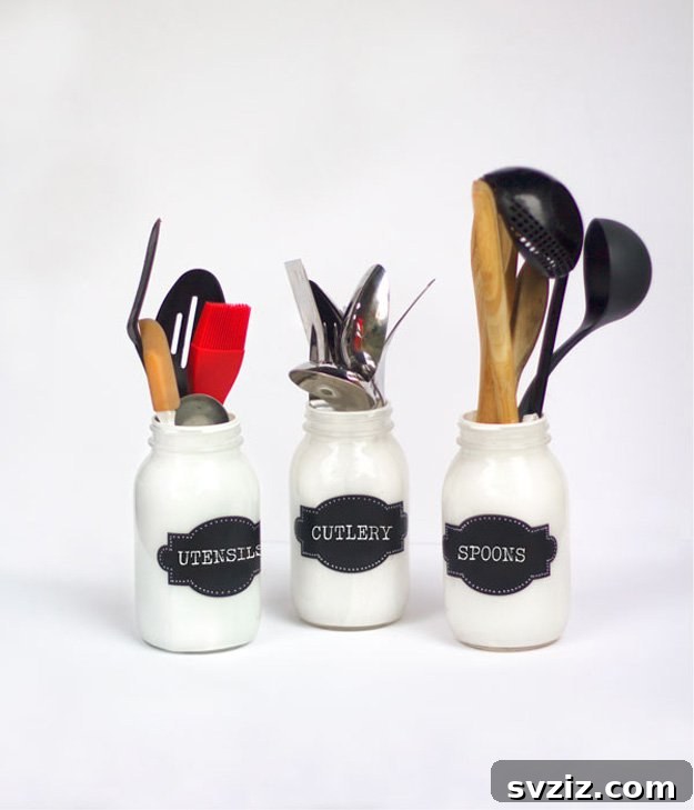 17 Smart Utensil Organizing Hacks 8 Beautiful painted mason jar utensil holders with chalkboard labels, adding a charming touch to kitchen storage