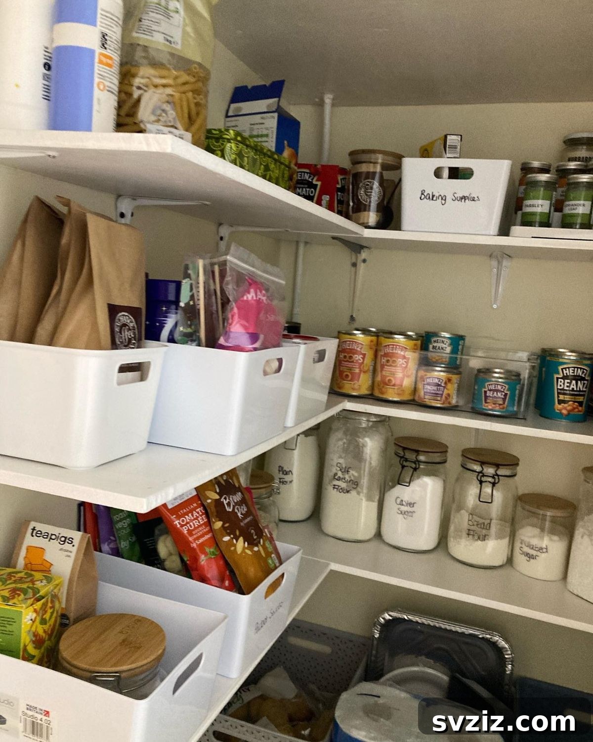 Clear plastic boxes on pantry shelves, providing simple and effective organization.