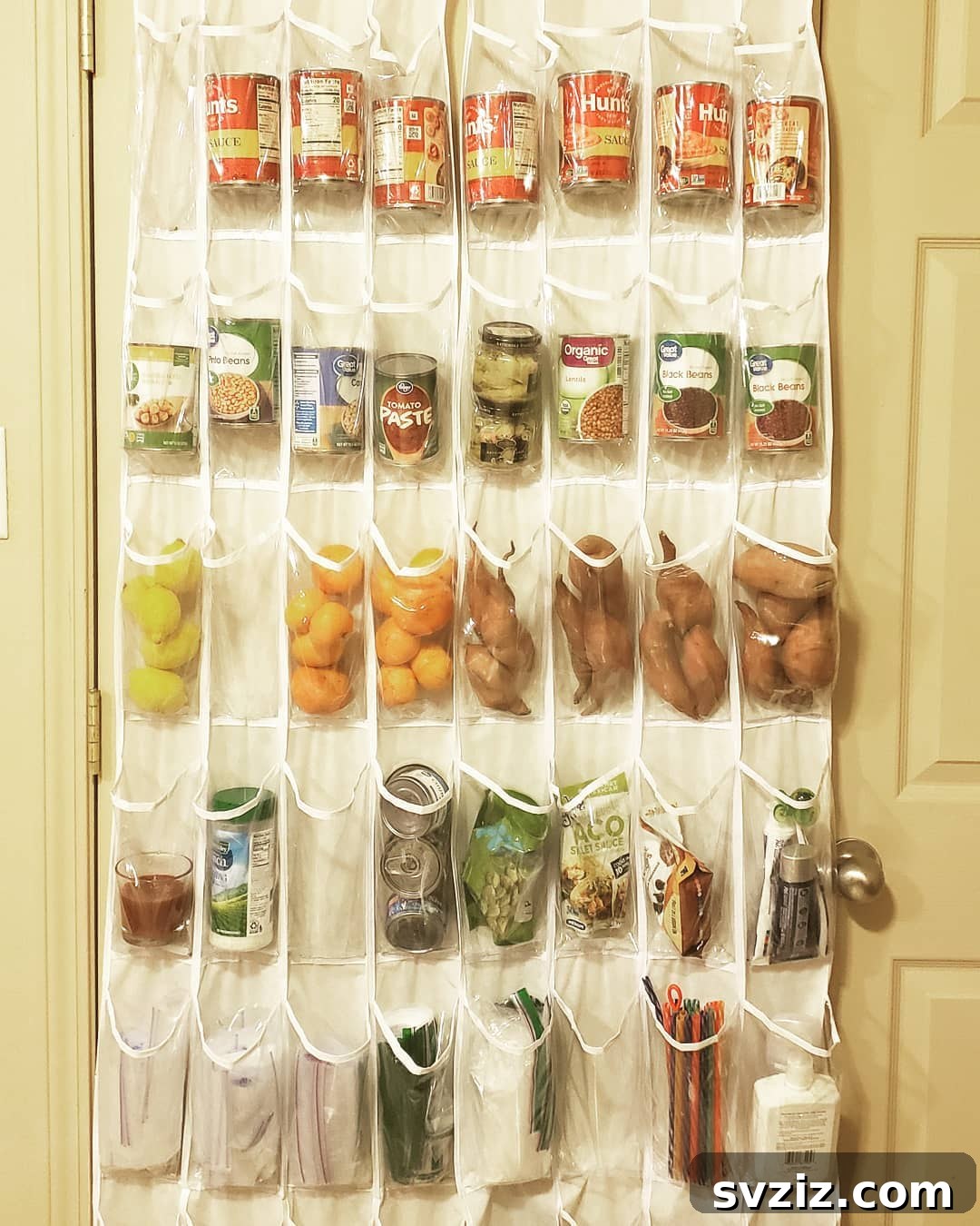 An over-the-door shoe holder repurposed for pantry storage, holding spices and small items.