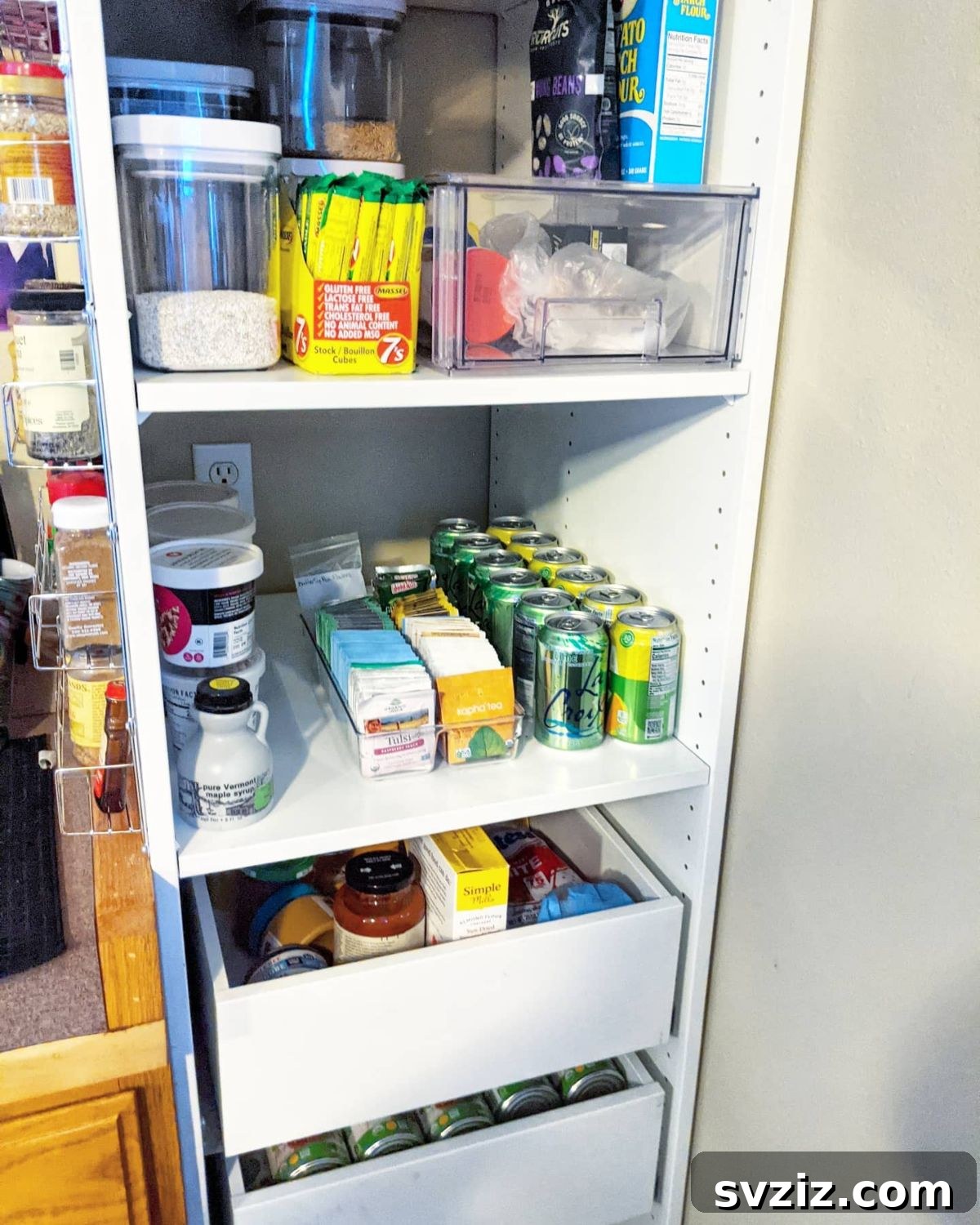 Various dry goods neatly decanted into clear glass containers on pantry shelves.