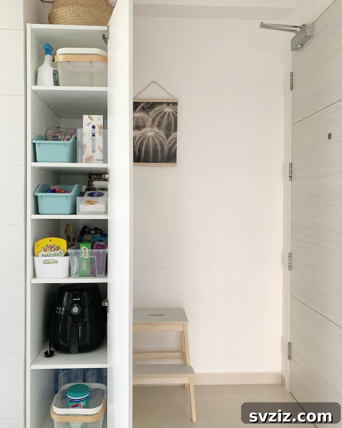 A narrow, floor-to-ceiling pantry cabinet, expertly organized with various storage solutions.