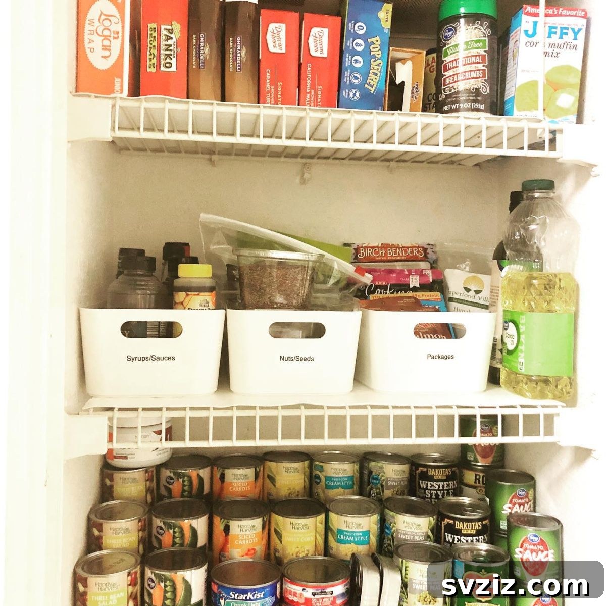 Labeled plastic bins on pantry shelves, providing clear and organized storage for various items.