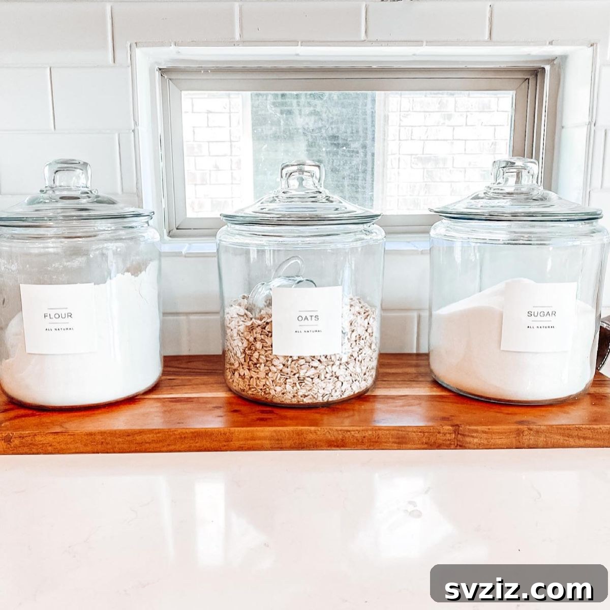 27 Chic & Stylish Home Organization Hacks for a Beautifully Transformed Space 26 Kitchen shelves with stylish glass containers for baking ingredients