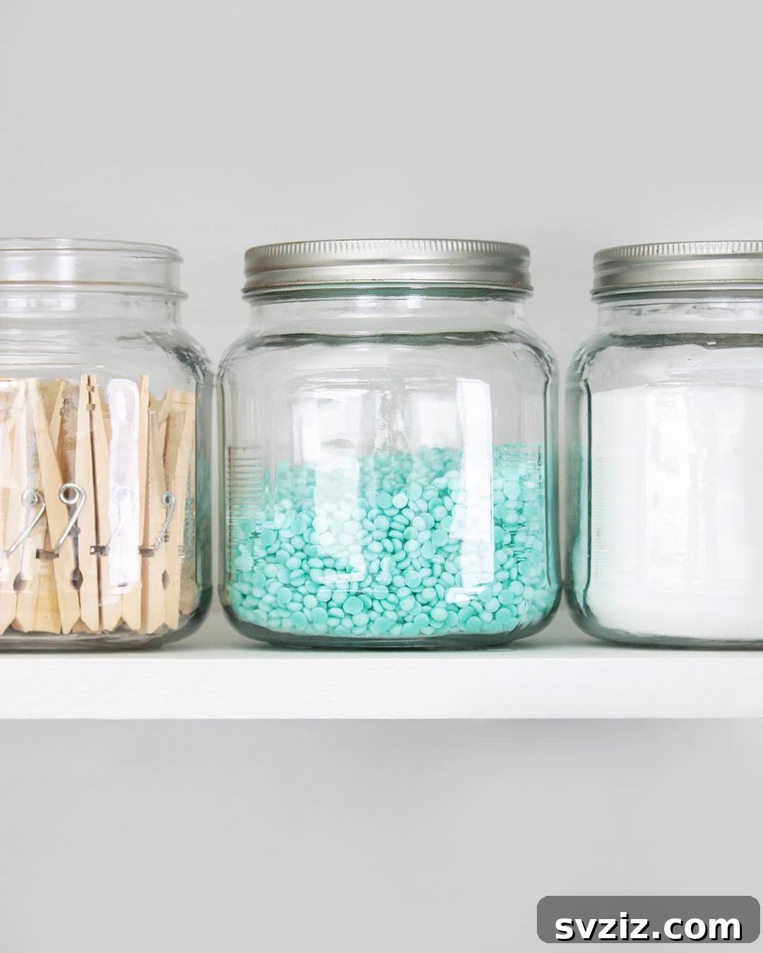 27 Chic & Stylish Home Organization Hacks for a Beautifully Transformed Space 5 Clear glass jars organizing laundry detergents and supplies