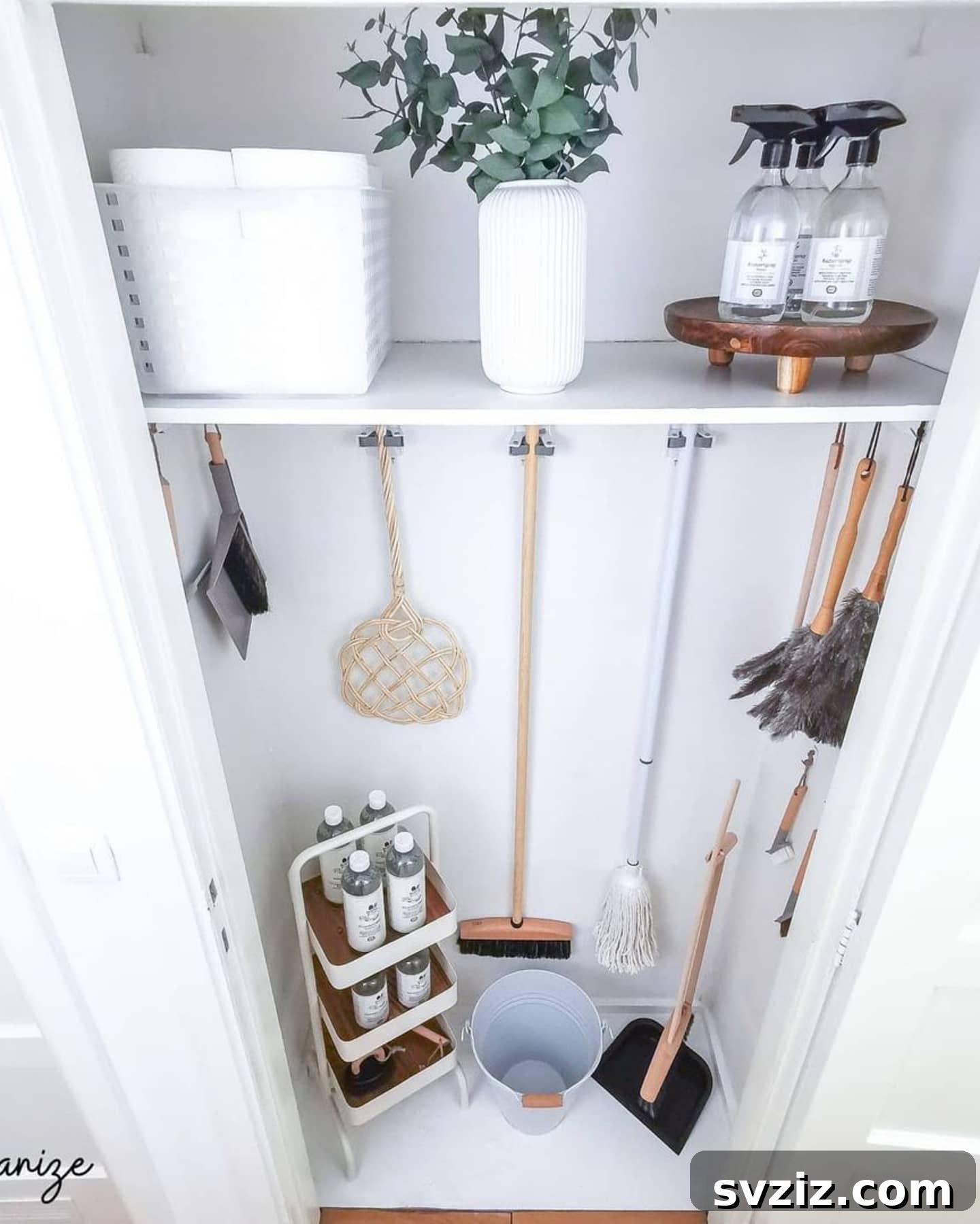 27 Chic & Stylish Home Organization Hacks for a Beautifully Transformed Space 6 Command grippers holding brooms and mops neatly in a cleaning closet