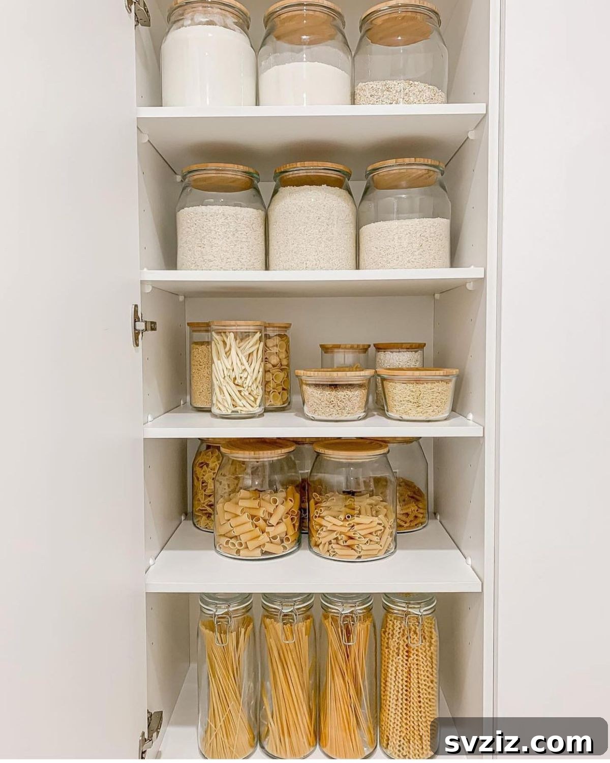 27 Chic & Stylish Home Organization Hacks for a Beautifully Transformed Space 7 Pantry organized with glass jars for pasta and other staples