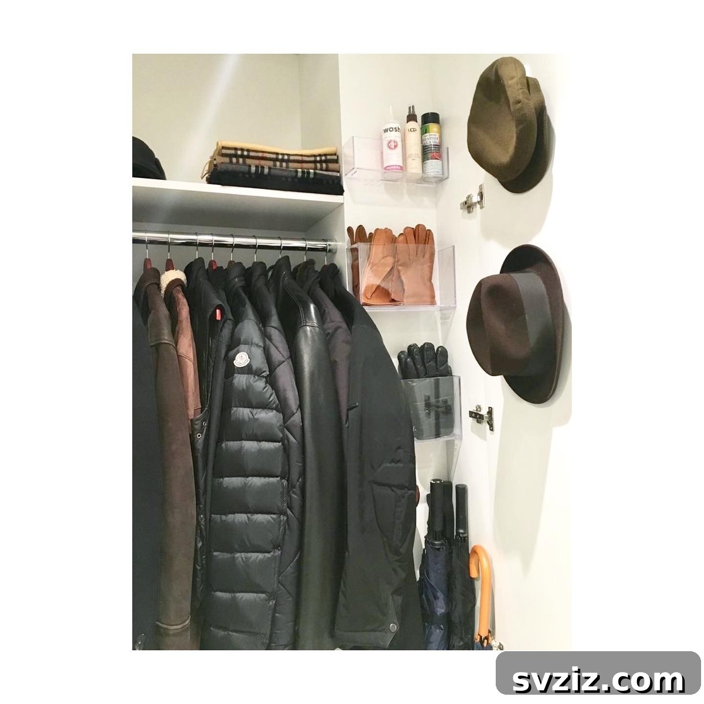 21 Genius Hacks to Master Your Coat Closet Organization 14 Coat closet wall with adhesive hooks and bins for hats and small items.