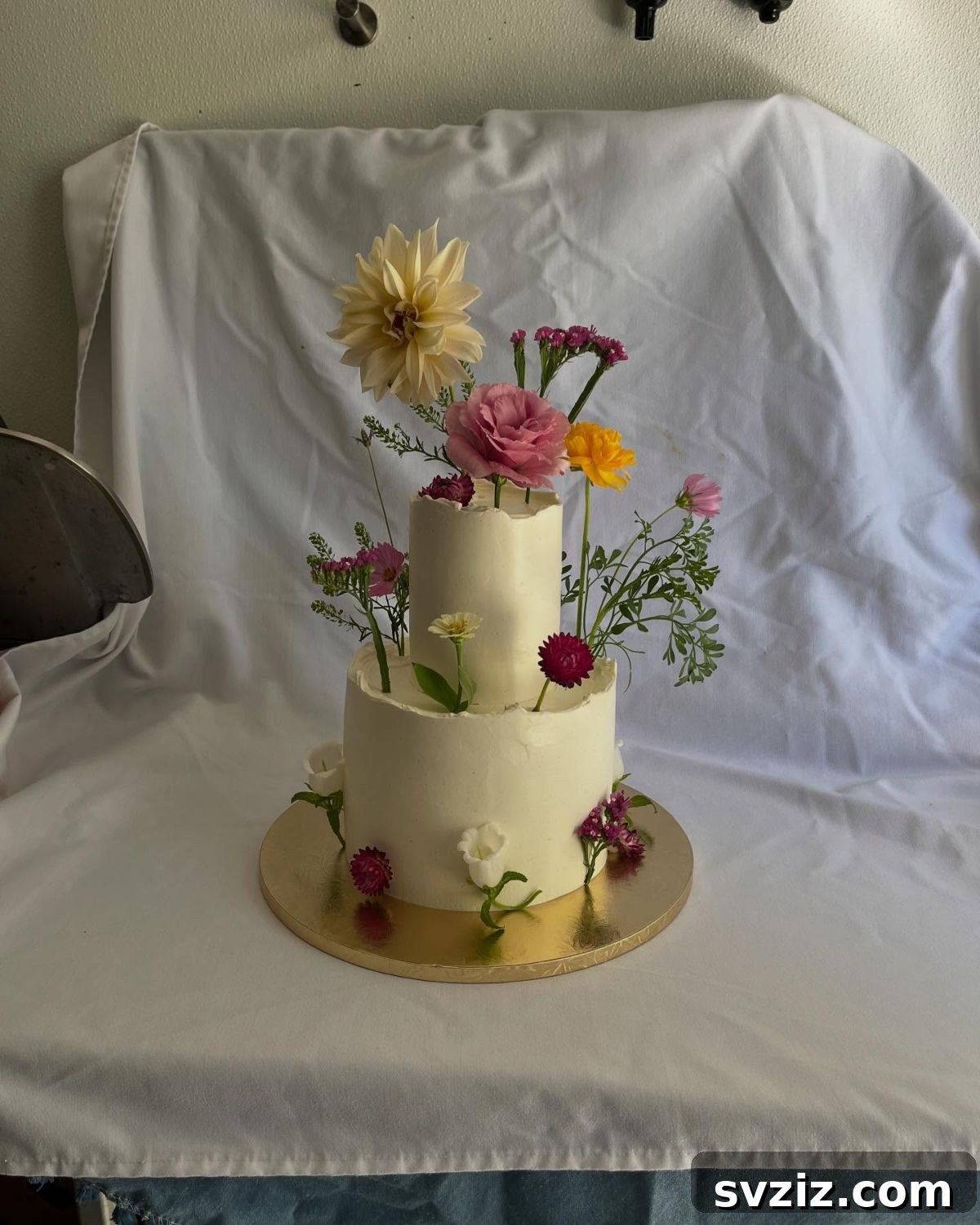 27 Elegant Wedding Cake Inspirations 9 A vibrant wedding cake showcasing a whimsical 'Flower Fantasy' with beautiful flowers of all colors, shapes, and sizes, creating a delightful work of art that brings nature's beauty to the celebration.