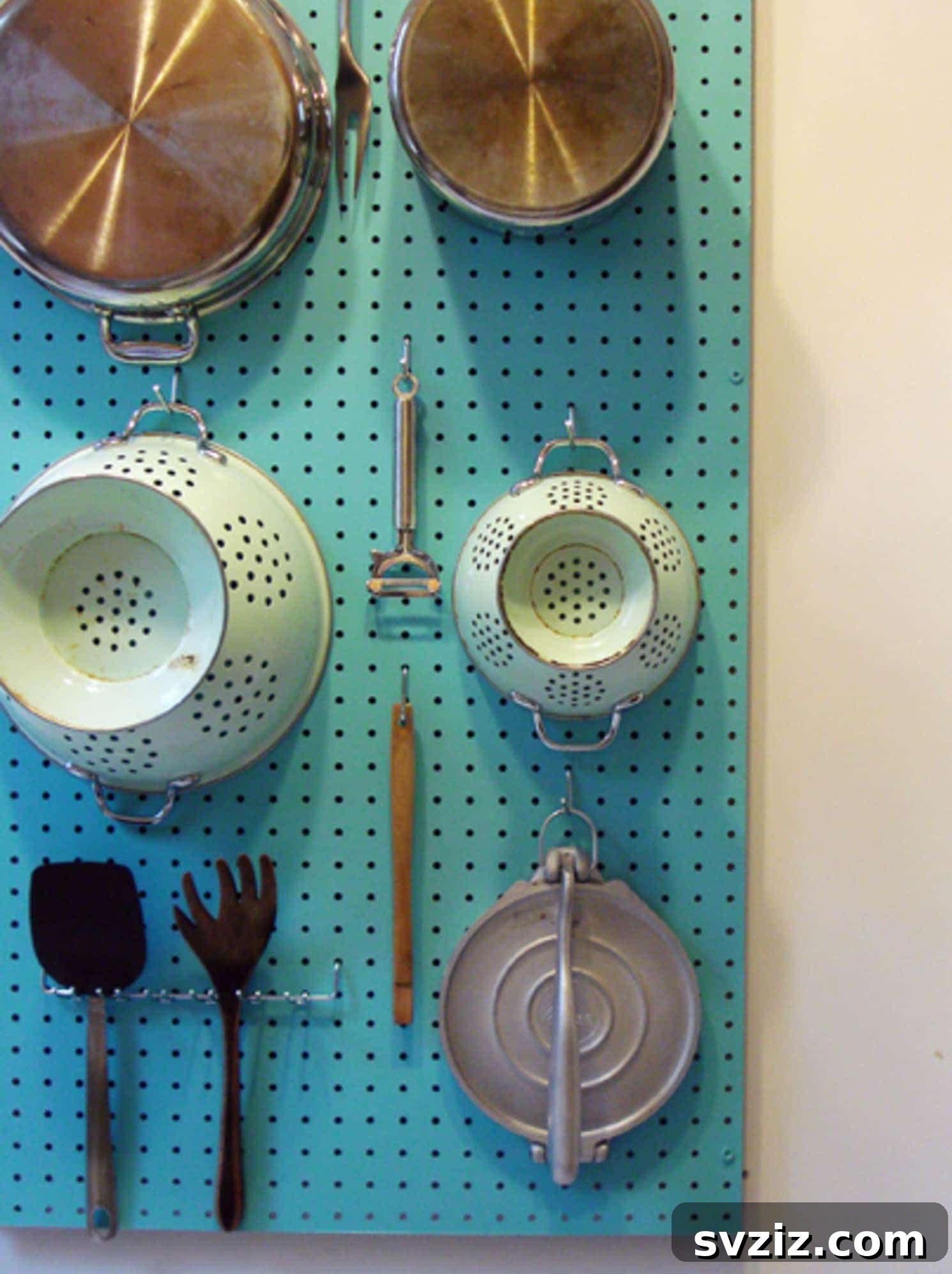 Kitchen pegboard organizing pots and pans