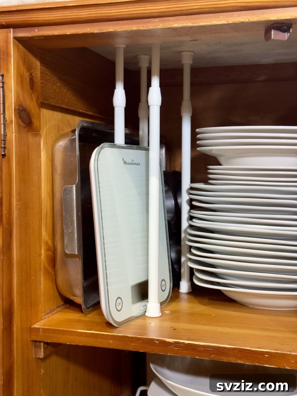 Tension rods used to organize baking sheets